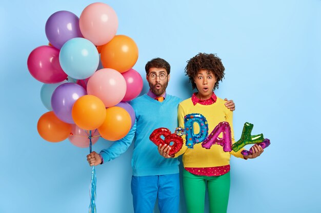 Sorpreso due multietnici donna e uomo vengono a congtratulare amico con un compleanno o un anniversario