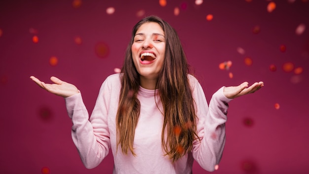 Sorridente ragazza bruna con coriandoli