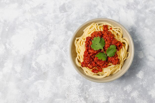 Spaghetti alla bolognese su cemento grigio