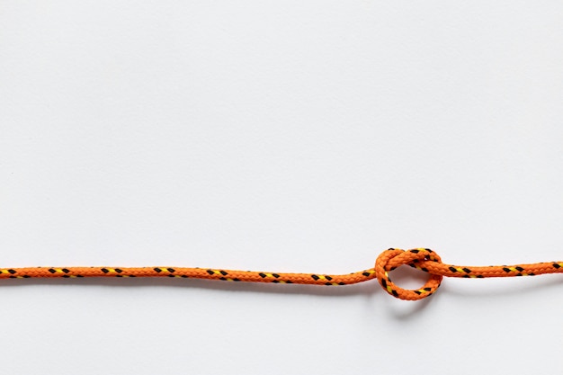 Spazio arancione nautico della copia del nodo della corda