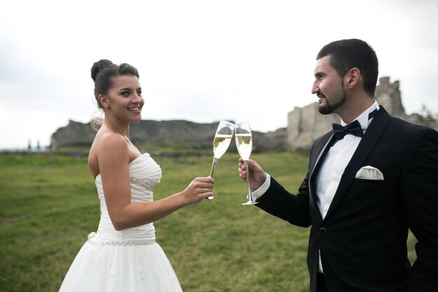 Sposo e sposa brindando con champagne