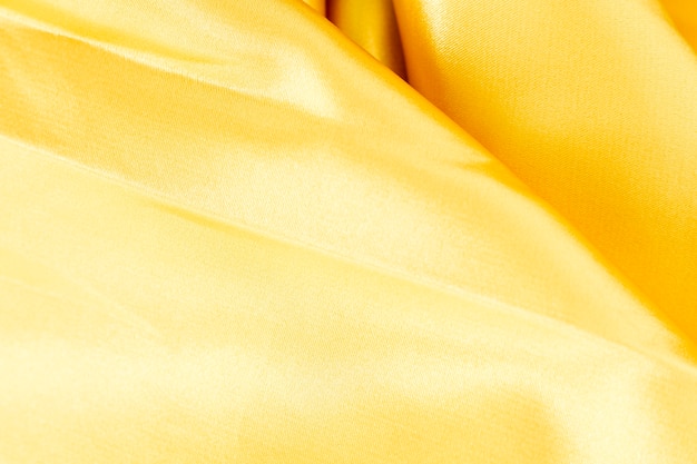 Struttura materiale del tessuto giallo con lo spazio della copia
