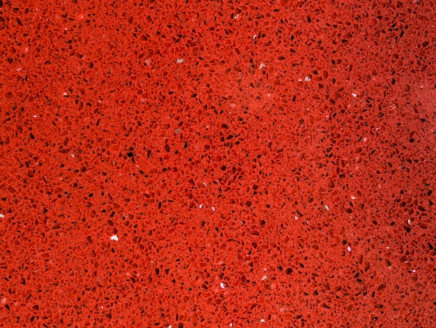 Strutturato rosso brillante del fondo delle mattonelle