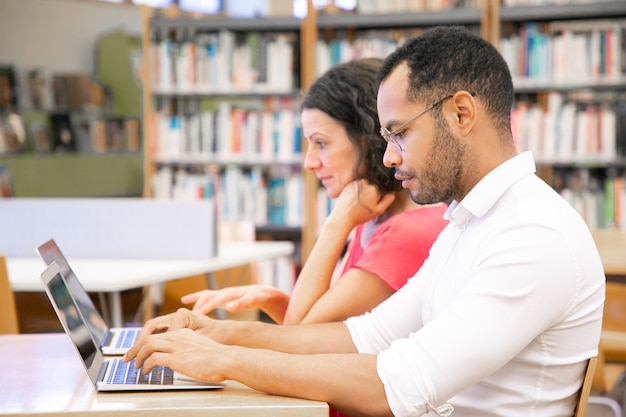 Studenti universitari che lavorano nella classe di computer della biblioteca