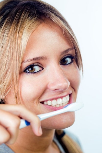 Studio Ritratto di bella giovane donna in posa con lo spazzolino da denti