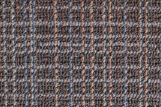 Superficie di fondo testurizzata del tappeto grigio decorata con motivo a linee incrociate multicolori