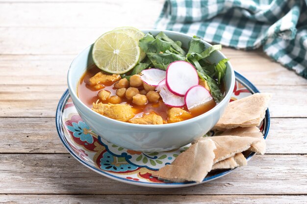 Suppa tradizionale messicana di pozole rosso su un tavolo di legno