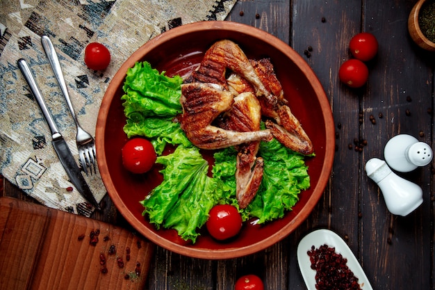 Tabacco di pollo fritto su lattuga e pomodori