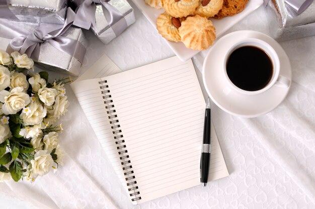 Taccuino e caffè con biscotti