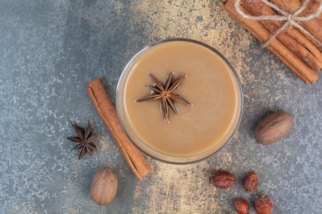 Tazza di caffè con bastoncini di cannella su sfondo marmo. Foto di alta qualità