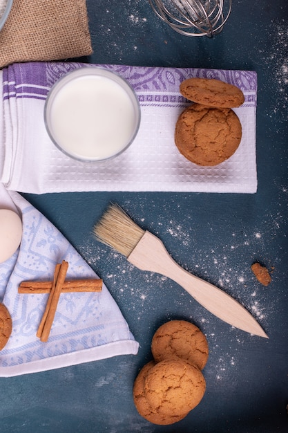 Tazza di latte con biscotti e pennello