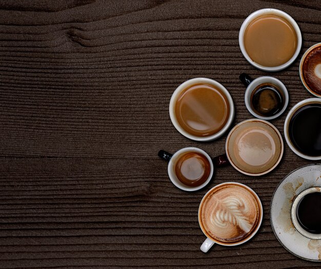 Tazze da caffè su una carta da parati strutturata in legno marrone scuro