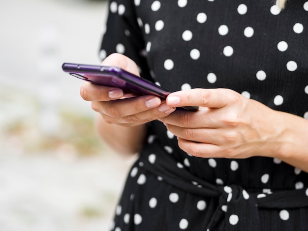 Telefono cellulare della tenuta della persona del primo piano