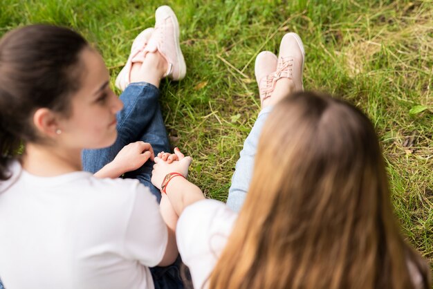 Tenersi per mano delle amiche di vista posteriore