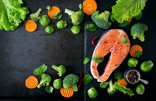 Trancio di salmone crudo e ingredienti per cucinare. Vista dall'alto