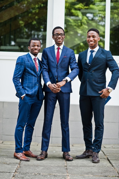 Tre uomini di successo felici afroamericani alla tuta