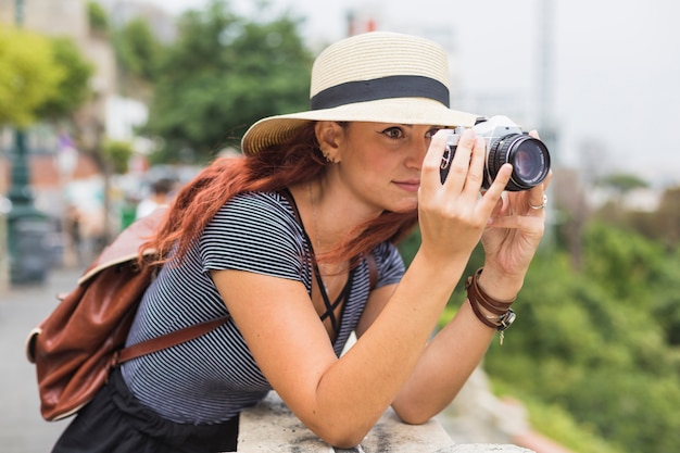 Turista femminile con la macchina fotografica sul balcone