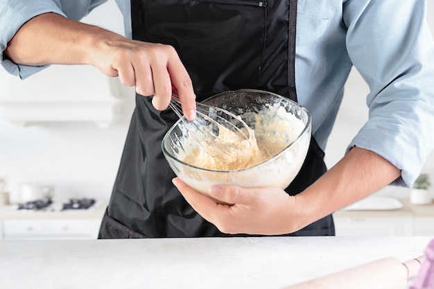 Un cuoco con le uova in una cucina rustica