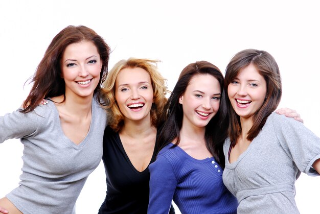 Un gruppo di quattro donne felici sexy, belle giovani. Isolato su bianco
