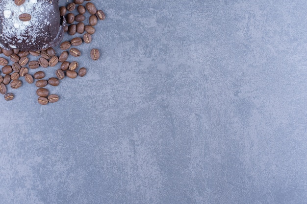 Un muffin al cioccolato con chicchi di caffè e zucchero in polvere