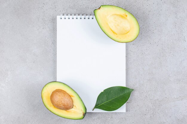 Un pezzo di carta vuoto con avocado a fette. Foto di alta qualità