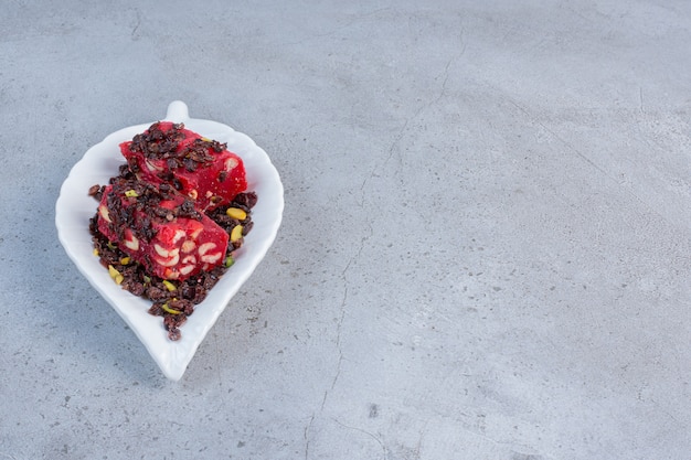 Un piccolo vassoio con delizie turche aromatizzate e colorate su fondo di marmo.