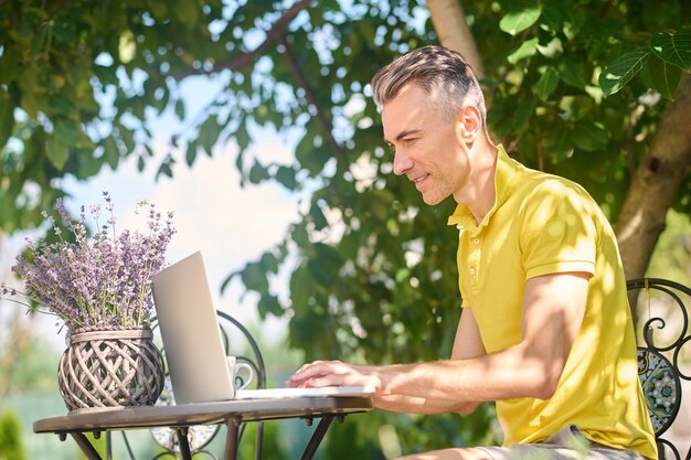 Un uomo che lavora su un laptop e sembra occupato