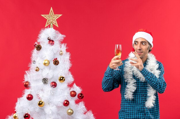 Un uomo è in piedi vicino all'albero di Natale