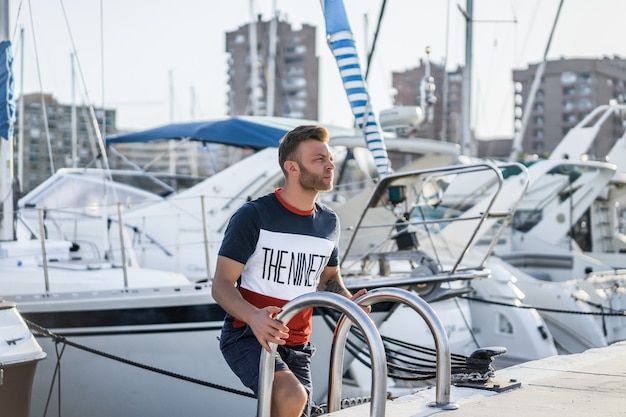 un uomo nel porto che prepara lo yacht per il viaggio