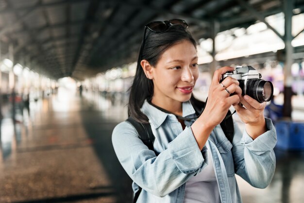 Un viaggiatore asiatico che usa una macchina fotografica