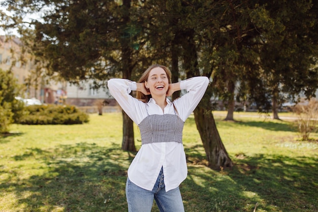 Una bella ragazza va in giro per la città sorridendo e posando