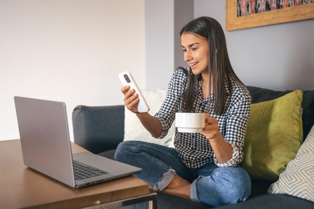 Una giovane donna che lavora su un laptop a casa