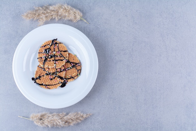 Una padella di waffle rotondi rossicci con granelli e panna