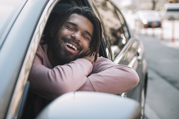 Uomo afroamericano che posa in automobile