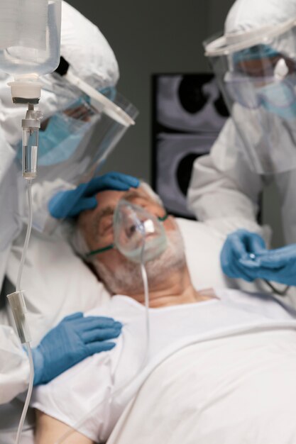 Uomo anziano che respira con un'attrezzatura speciale in ospedale