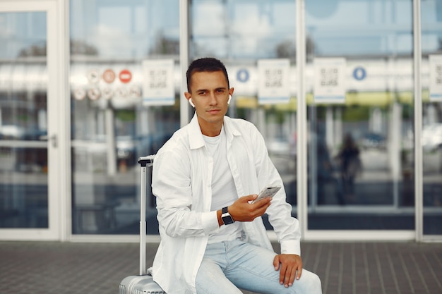 Uomo bello che sta vicino all'aeroporto