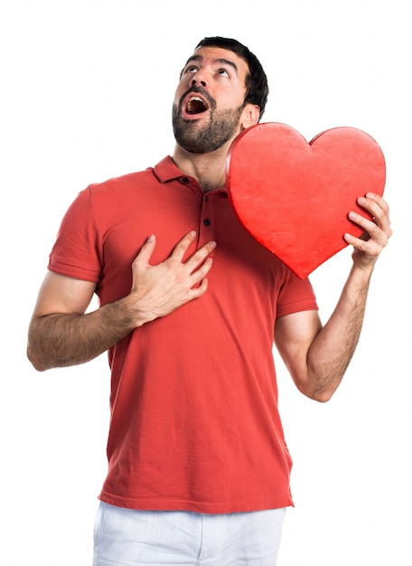 Uomo bello con un&#39;icona del cuore