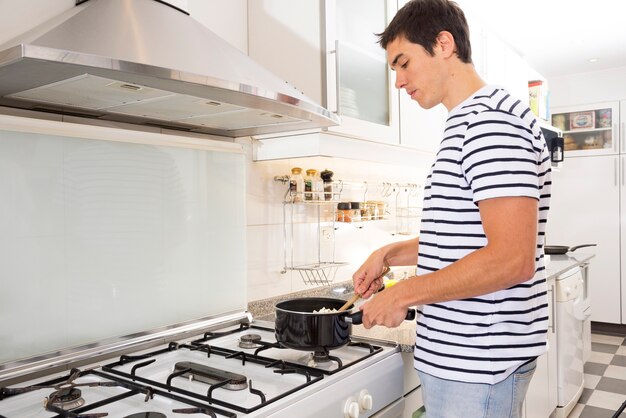 Uomo che cucina cibo in cucina