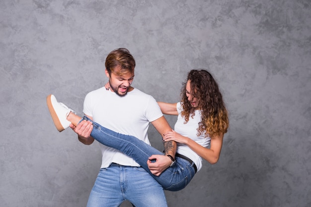 Uomo che gioca sulla gamba della donna come alla chitarra