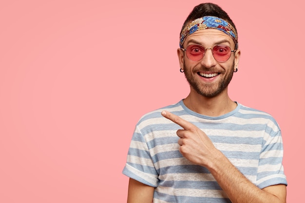 Uomo che indossa occhiali da sole rosa e bandana colorata