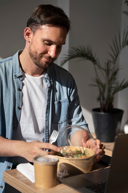 Uomo che si gode il cibo da asporto