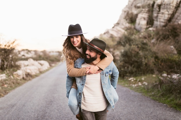 Uomo che tiene bella donna e che cammina sulla strada