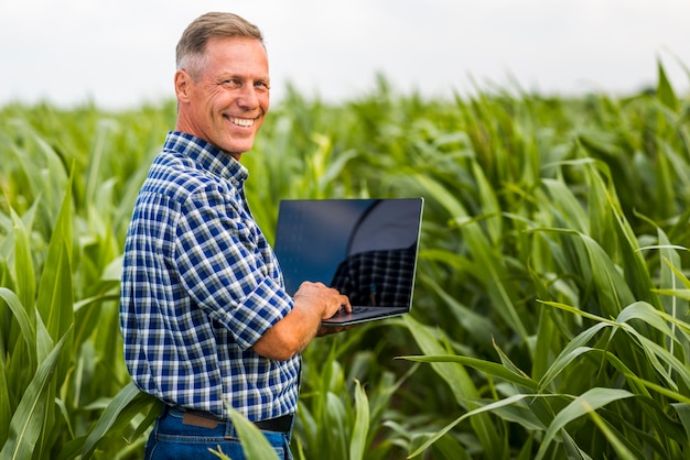 Uomo con un computer portatile che guarda l'obbiettivo