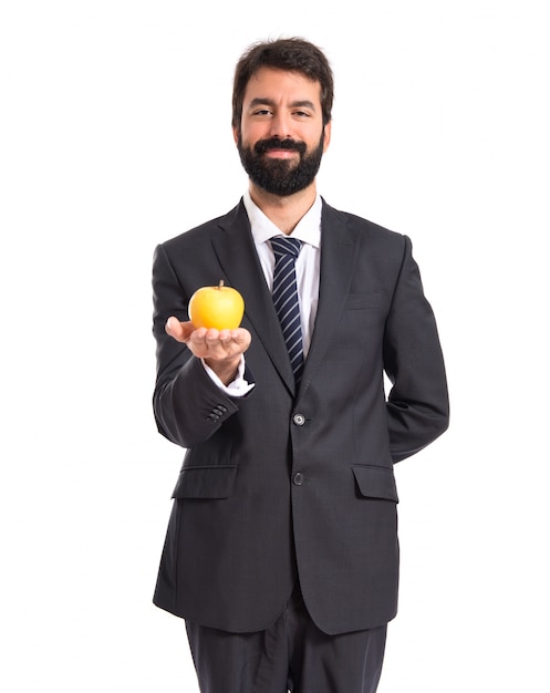 Uomo d&#39;affari in possesso di una mela su bianco