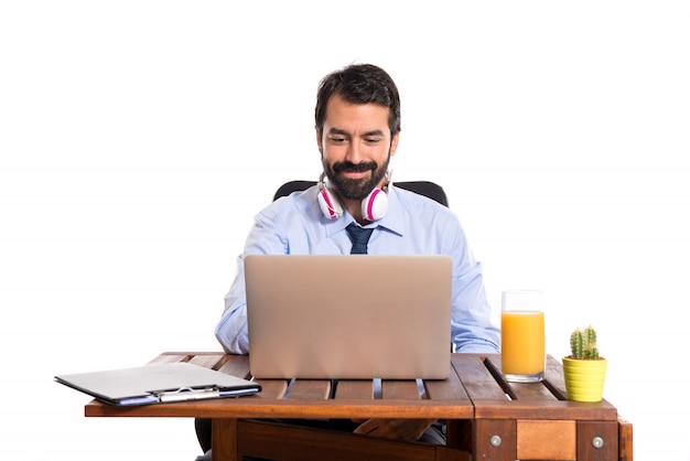 Uomo d&#39;affari nel suo ufficio ascoltando musica