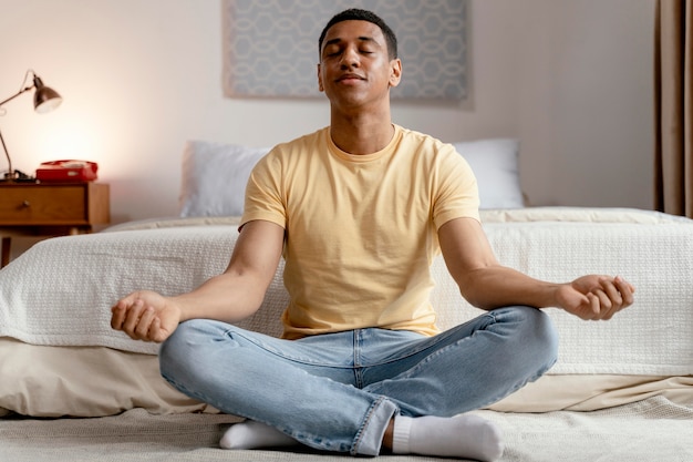 Uomo del ritratto a casa meditando