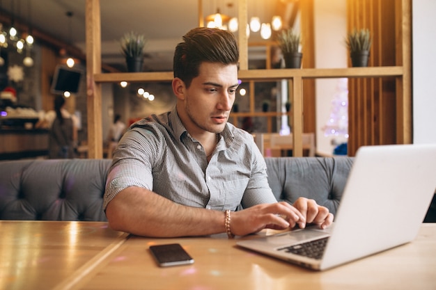 Uomo di affari che comunica sul telefono in un caffè