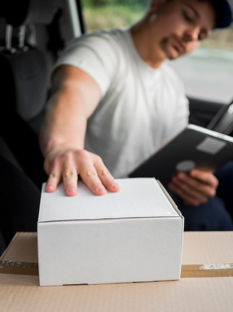 Uomo di consegna offuscata vista laterale in auto