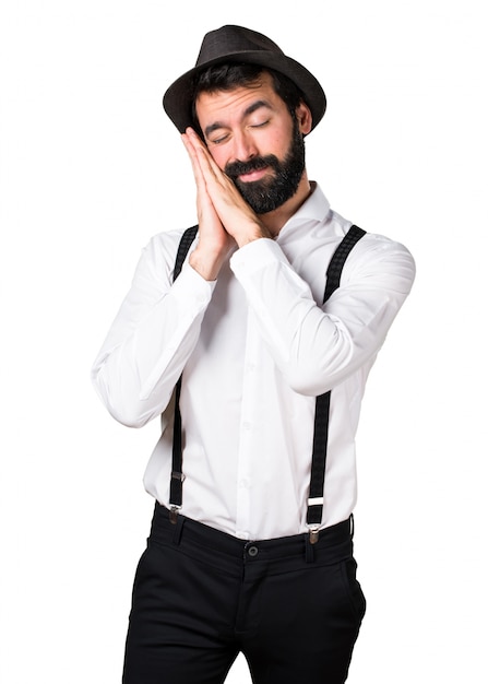 Uomo di Hipster con la barba facendo il gesto di sonno