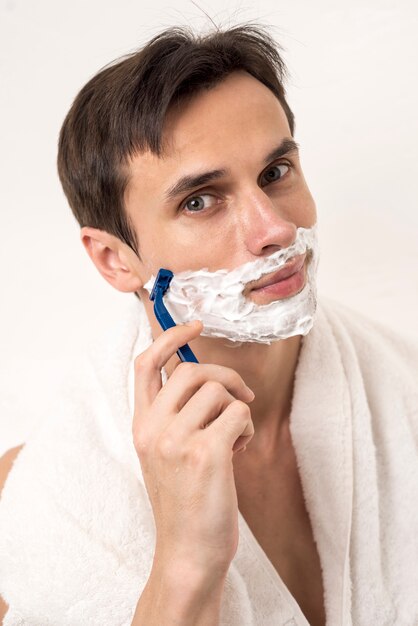 Uomo di vista frontale che rade barba